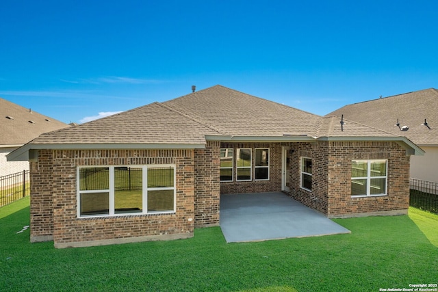 rear view of house with a patio and a lawn