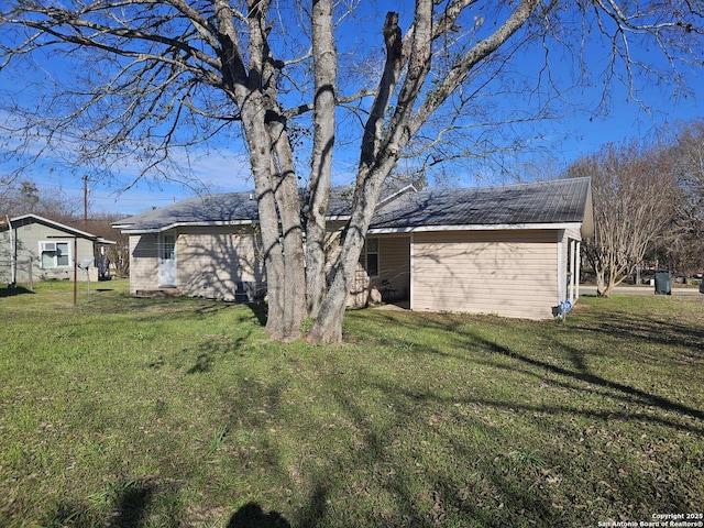 view of side of property with a yard