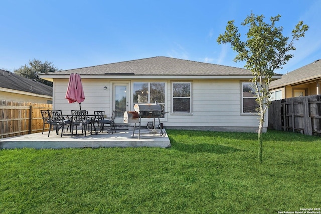 back of property featuring a lawn and a patio area