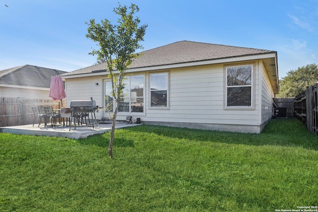 back of house featuring central air condition unit, a patio area, and a yard