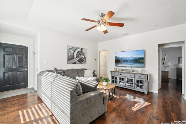 living room with ceiling fan and dark wood-type flooring