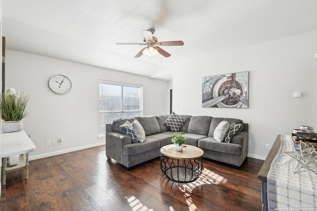 living room featuring ceiling fan and dark hardwood / wood-style flooring