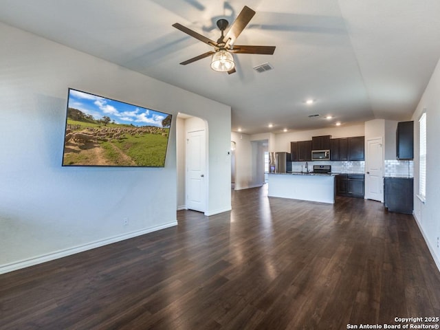 unfurnished living room with ceiling fan and dark hardwood / wood-style flooring