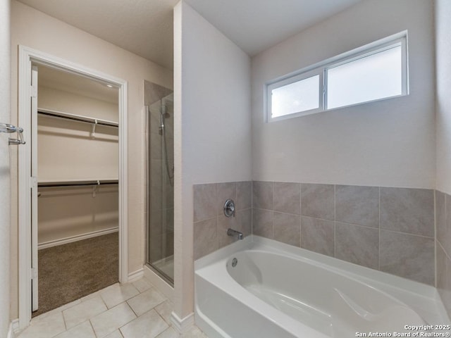 bathroom featuring tile patterned flooring and independent shower and bath