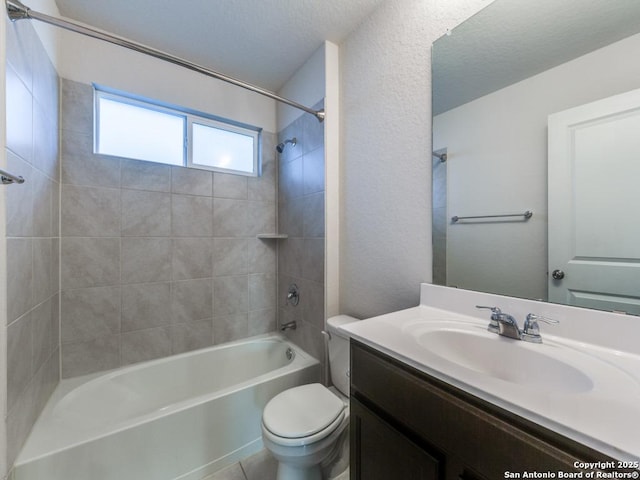 full bathroom featuring tiled shower / bath combo, toilet, and vanity