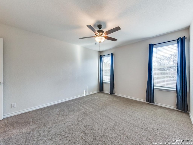 spare room featuring carpet floors and ceiling fan