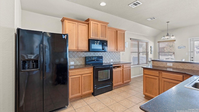 kitchen with hanging light fixtures, a notable chandelier, lofted ceiling, light tile patterned flooring, and black appliances