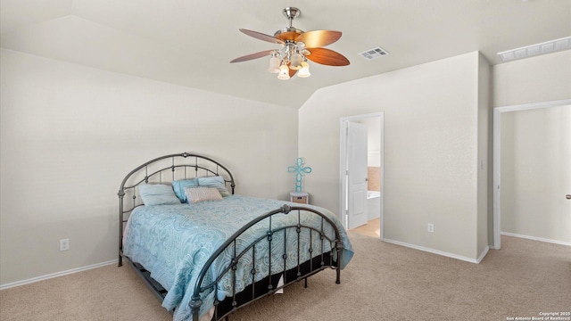 bedroom featuring ensuite bathroom, vaulted ceiling, ceiling fan, and light colored carpet