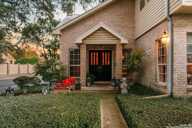 view of exterior entry at dusk