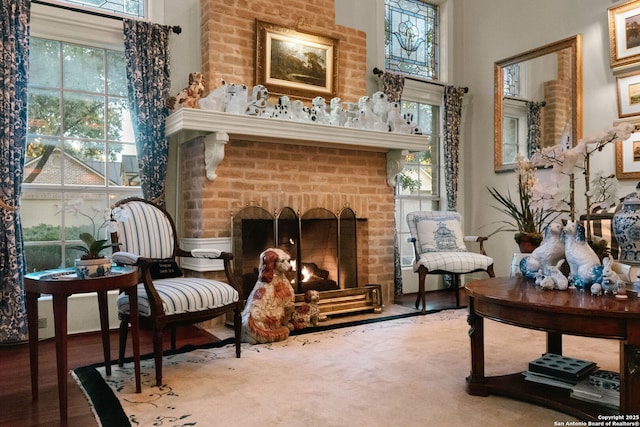 sitting room featuring a brick fireplace