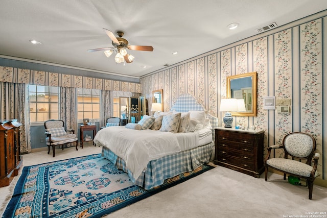 bedroom featuring light colored carpet and ceiling fan