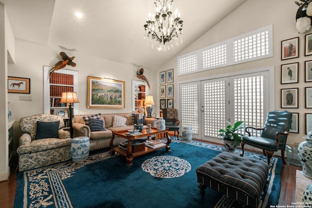 living room with high vaulted ceiling, a chandelier, and hardwood / wood-style flooring