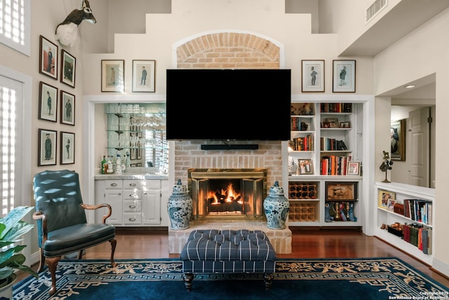 living area with a fireplace and dark hardwood / wood-style floors