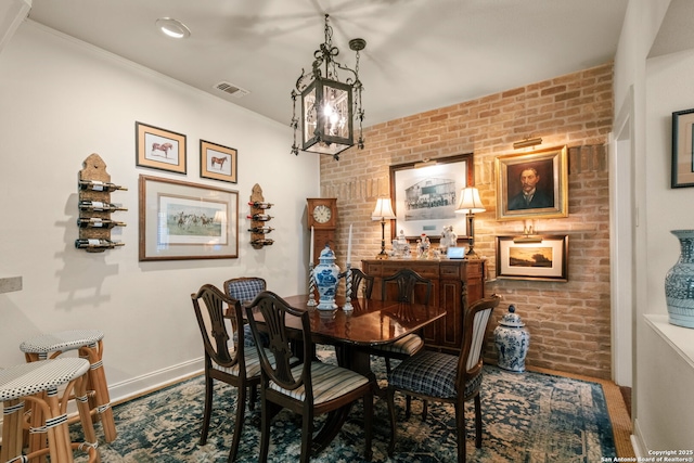 dining room featuring brick wall