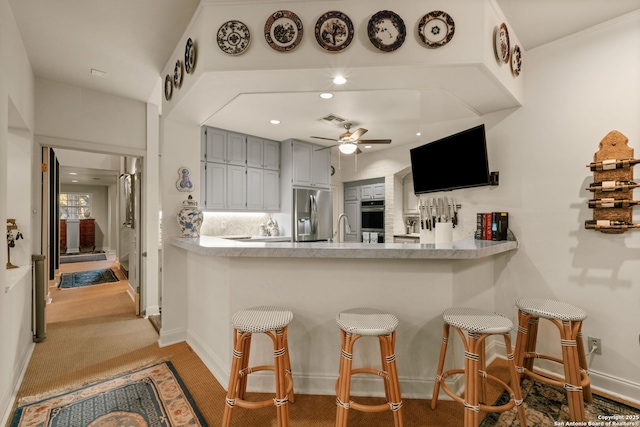 kitchen with tasteful backsplash, gray cabinetry, stainless steel appliances, ceiling fan, and sink