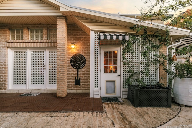 exterior entry at dusk with a patio