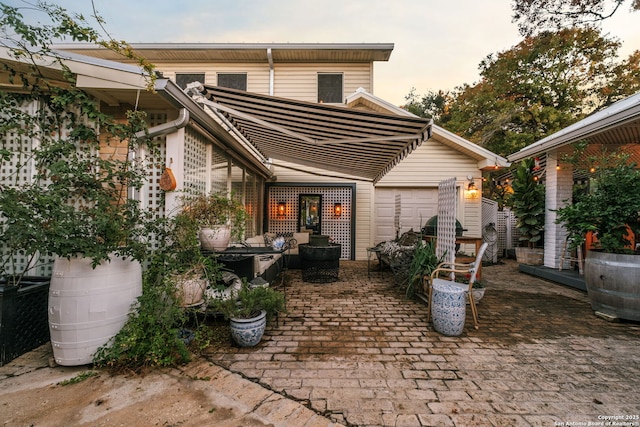 back house at dusk with a patio