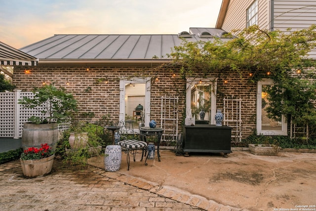 exterior entry at dusk with a patio area