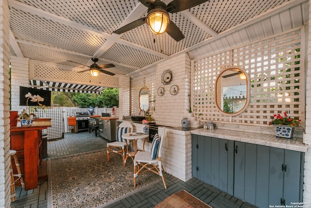 view of patio / terrace with ceiling fan and exterior bar