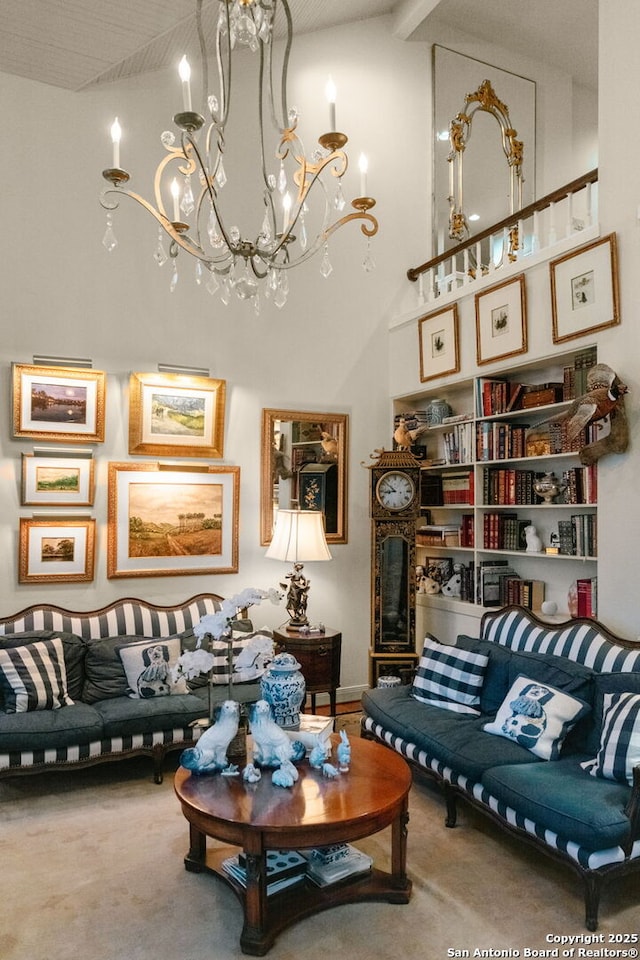 carpeted living room with a high ceiling and an inviting chandelier