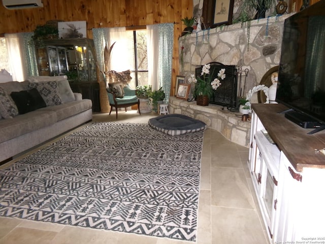 living room with a wall mounted AC, wood walls, and a fireplace