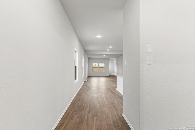 hallway with hardwood / wood-style floors