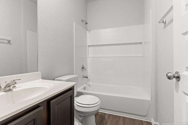 full bathroom featuring bathing tub / shower combination, hardwood / wood-style floors, vanity, and toilet