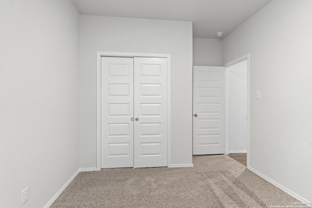 unfurnished bedroom with carpet and a closet