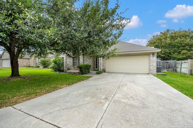 view of front of home featuring a front yard and a garage