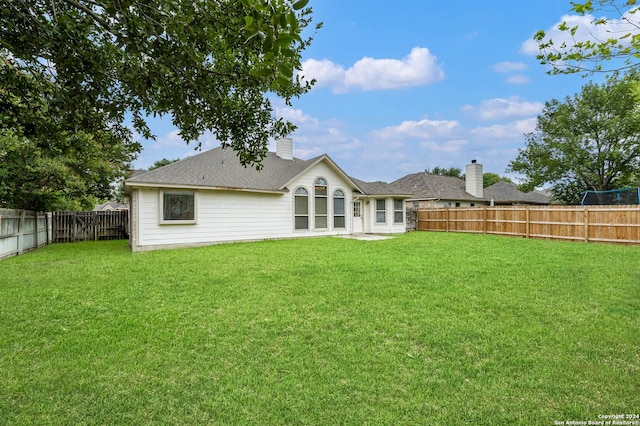 back of house featuring a yard