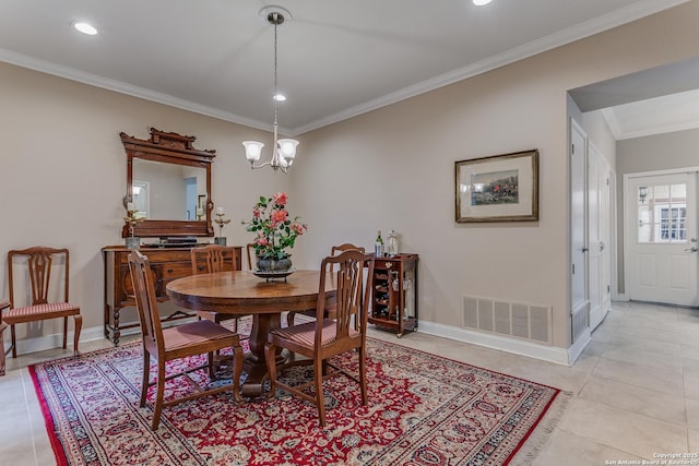 tiled dining area with crown molding and a chandelier