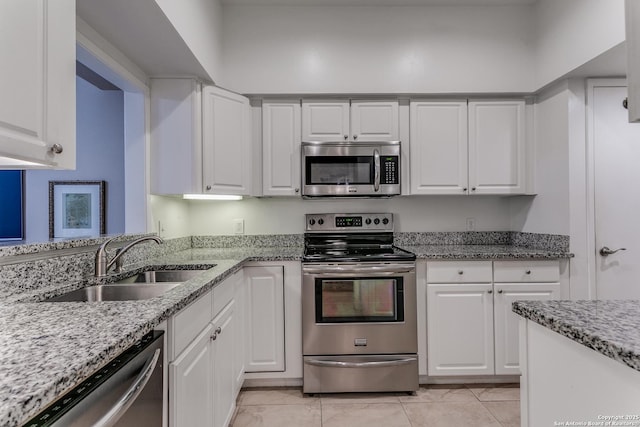 kitchen featuring white cabinets, stainless steel appliances, and sink