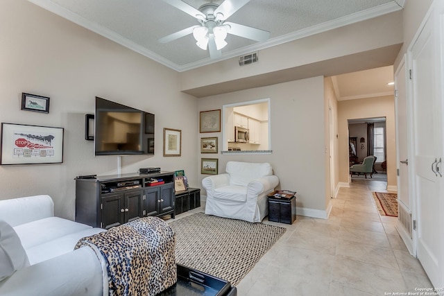 living room with ceiling fan, crown molding, light tile patterned floors, and a textured ceiling