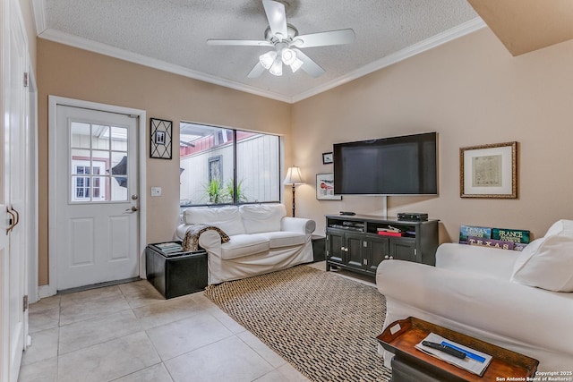 living room featuring ceiling fan, light tile patterned floors, a textured ceiling, and ornamental molding