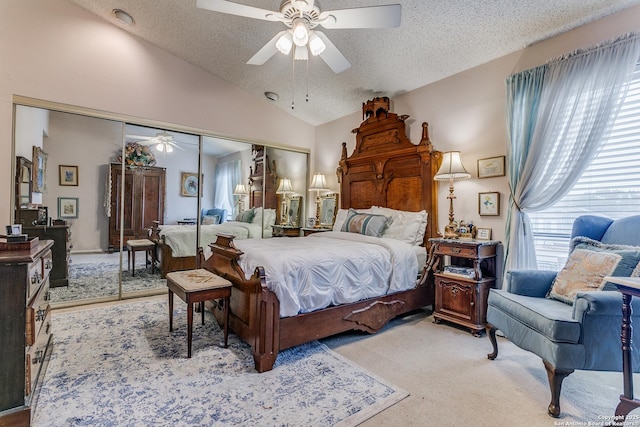 bedroom with ceiling fan, light colored carpet, a textured ceiling, lofted ceiling, and a closet