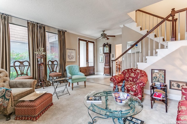 living room featuring french doors, a textured ceiling, light colored carpet, and a wealth of natural light