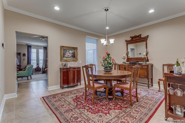 dining area with light tile patterned flooring, crown molding, and a chandelier