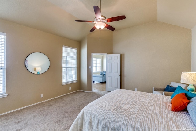 bedroom with carpet flooring, baseboards, lofted ceiling, and a ceiling fan