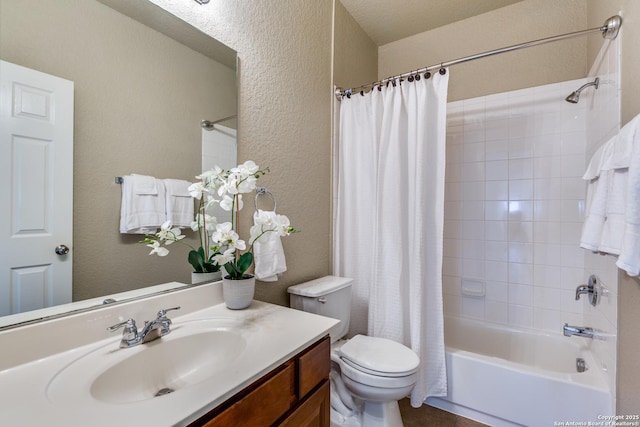 bathroom featuring toilet, shower / bath combo, vanity, and a textured wall