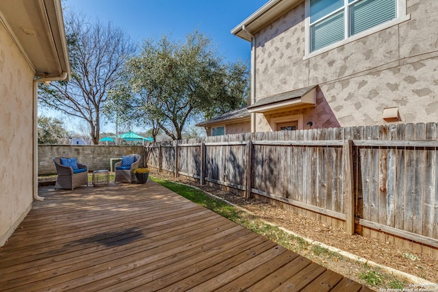 wooden deck featuring a fenced backyard