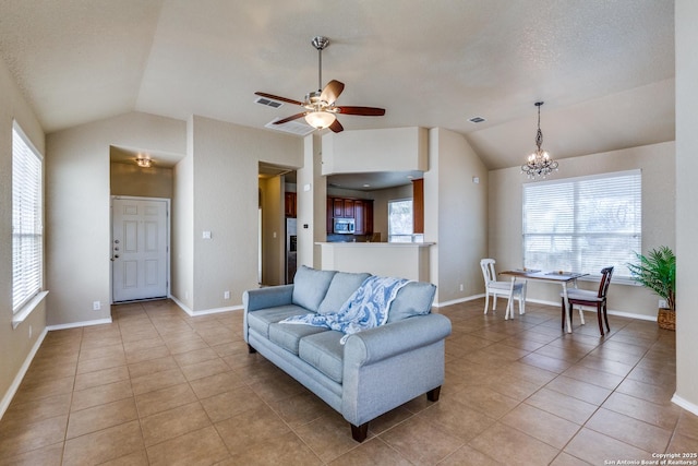 living area with lofted ceiling, light tile patterned flooring, baseboards, and visible vents