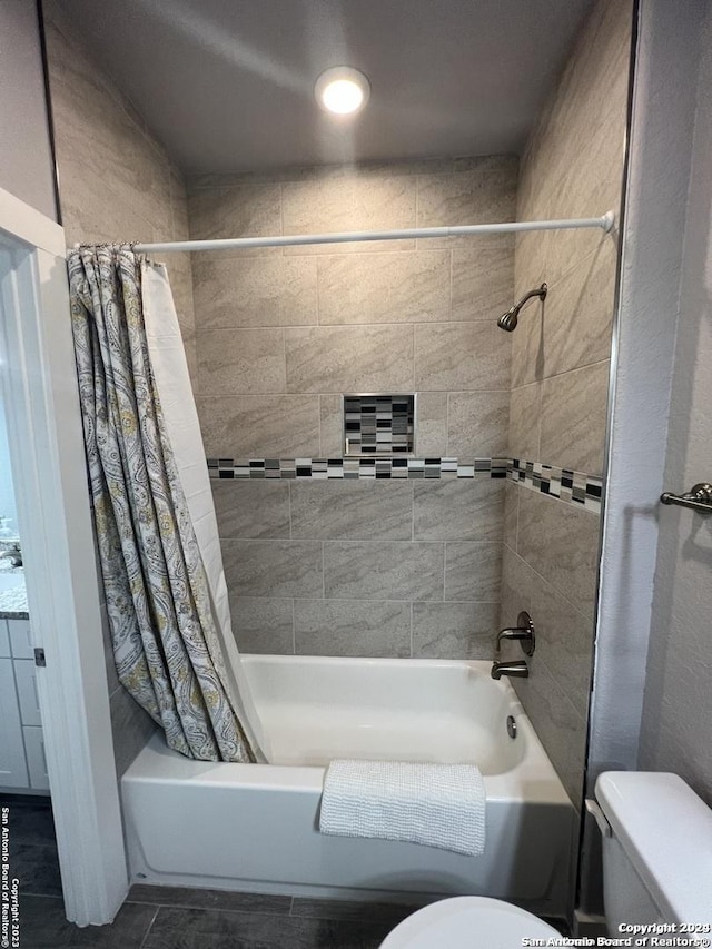 bathroom with shower / bath combo with shower curtain and toilet