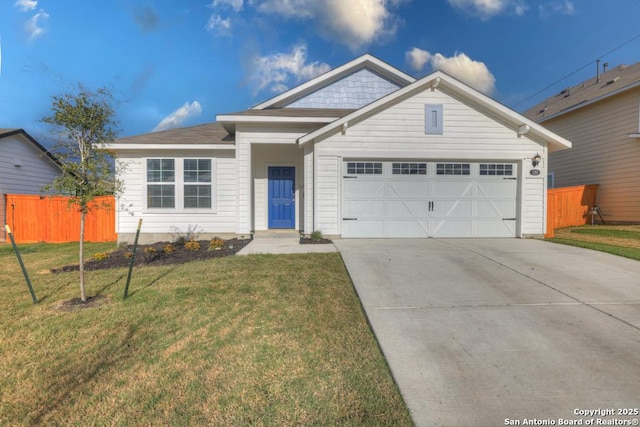 view of front of home with a garage and a front lawn