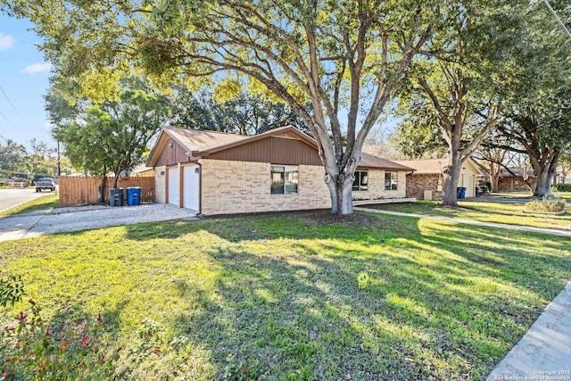 view of front of home with a garage and a front lawn