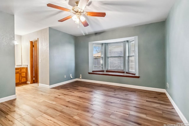 unfurnished room with ceiling fan and light hardwood / wood-style floors