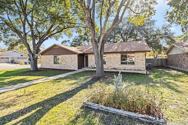 single story home with central air condition unit and a front lawn