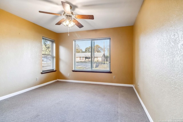 carpeted empty room with ceiling fan