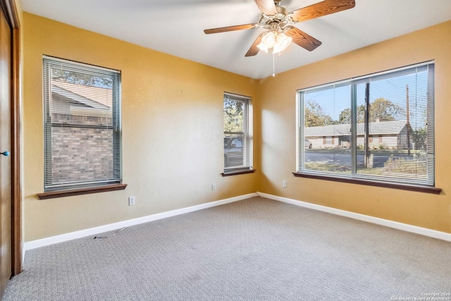 spare room with carpet and ceiling fan