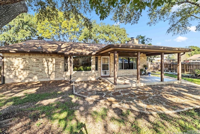 back of house with a patio