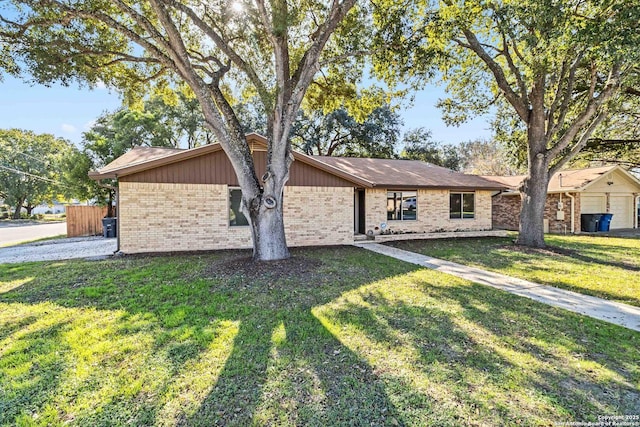 ranch-style home featuring a front yard and a garage